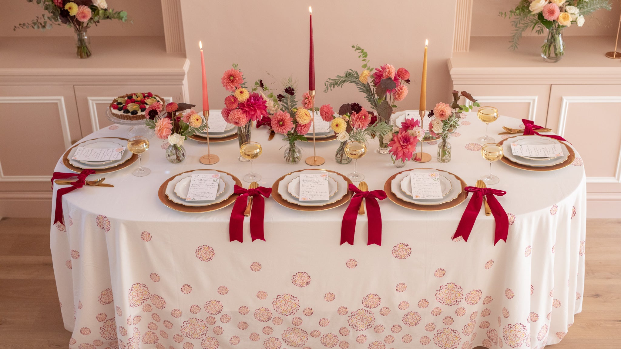 Fall dahlia autumn tablescape with taper dinner candles and red velvet bows