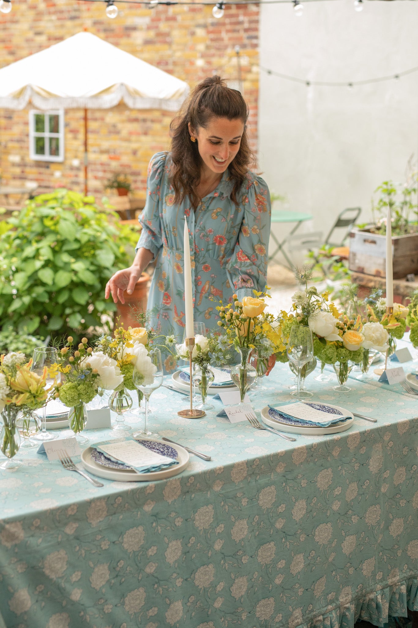 Rosanna Falconer next to peony bloom blue tablecloth and full tablescape