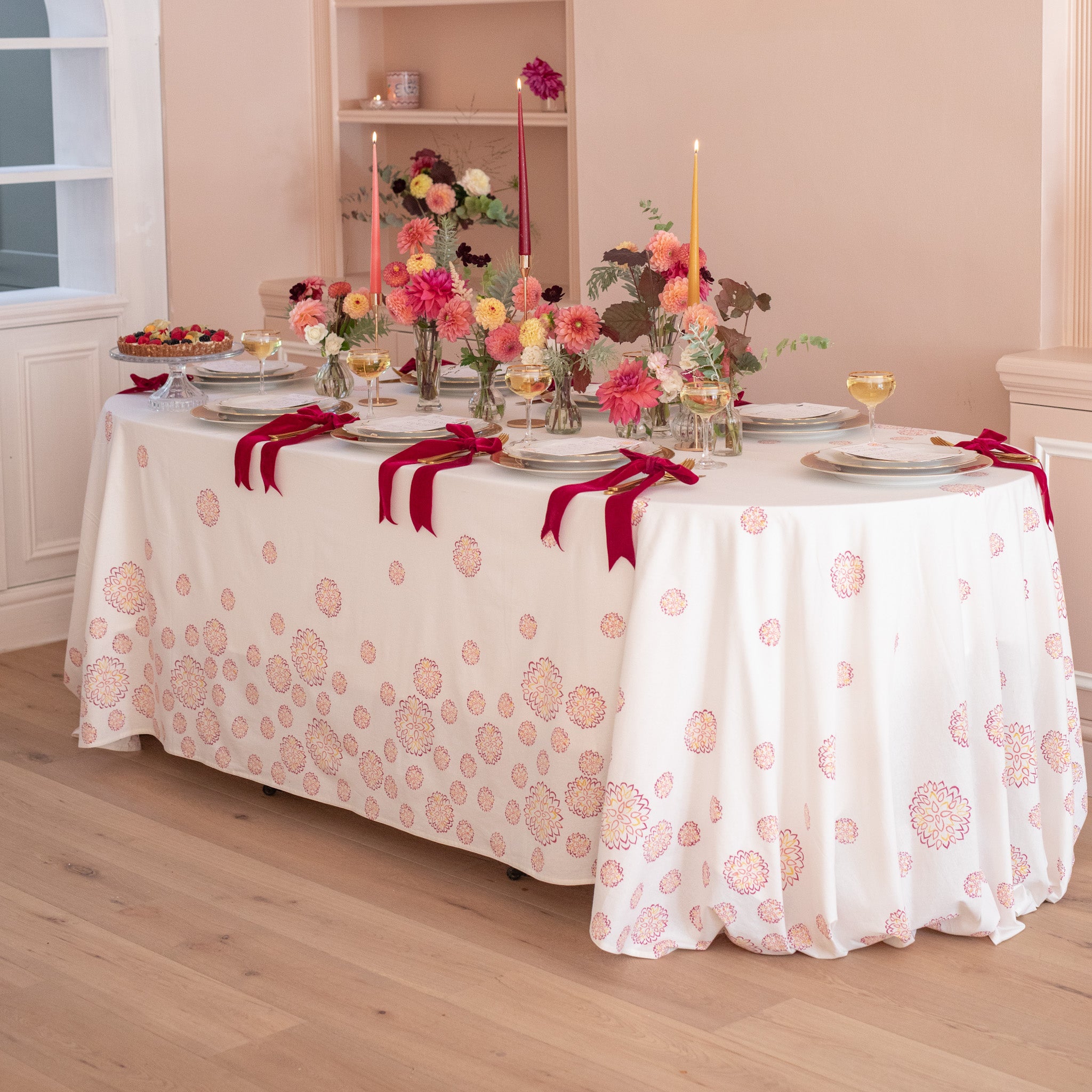 Tablecloth with block printed dahlia flowers on a white cotton background