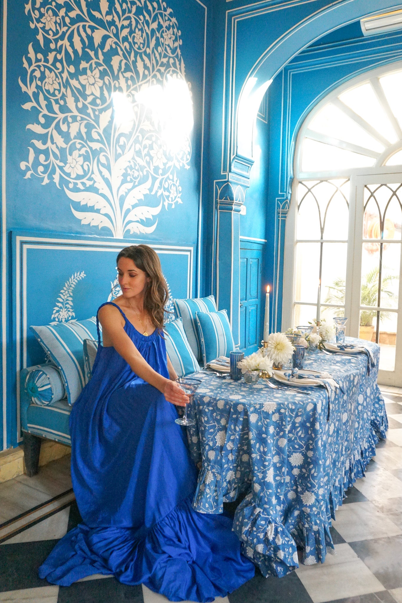 Bar Palladio Rosanna Falconer in blue Kalita dress sitting at table
