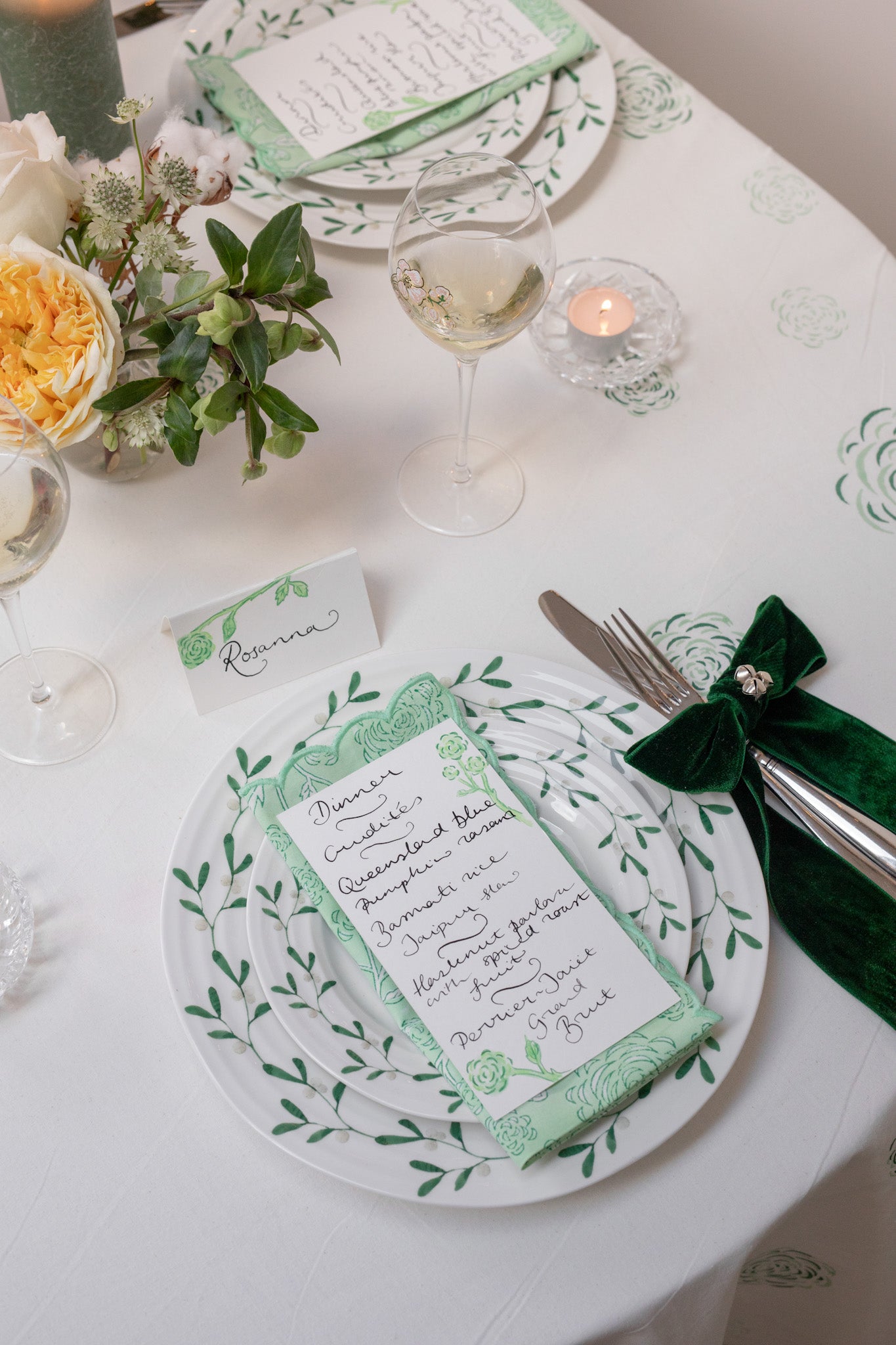 Detail of Christmas green and white tablescape with calligraphy menu