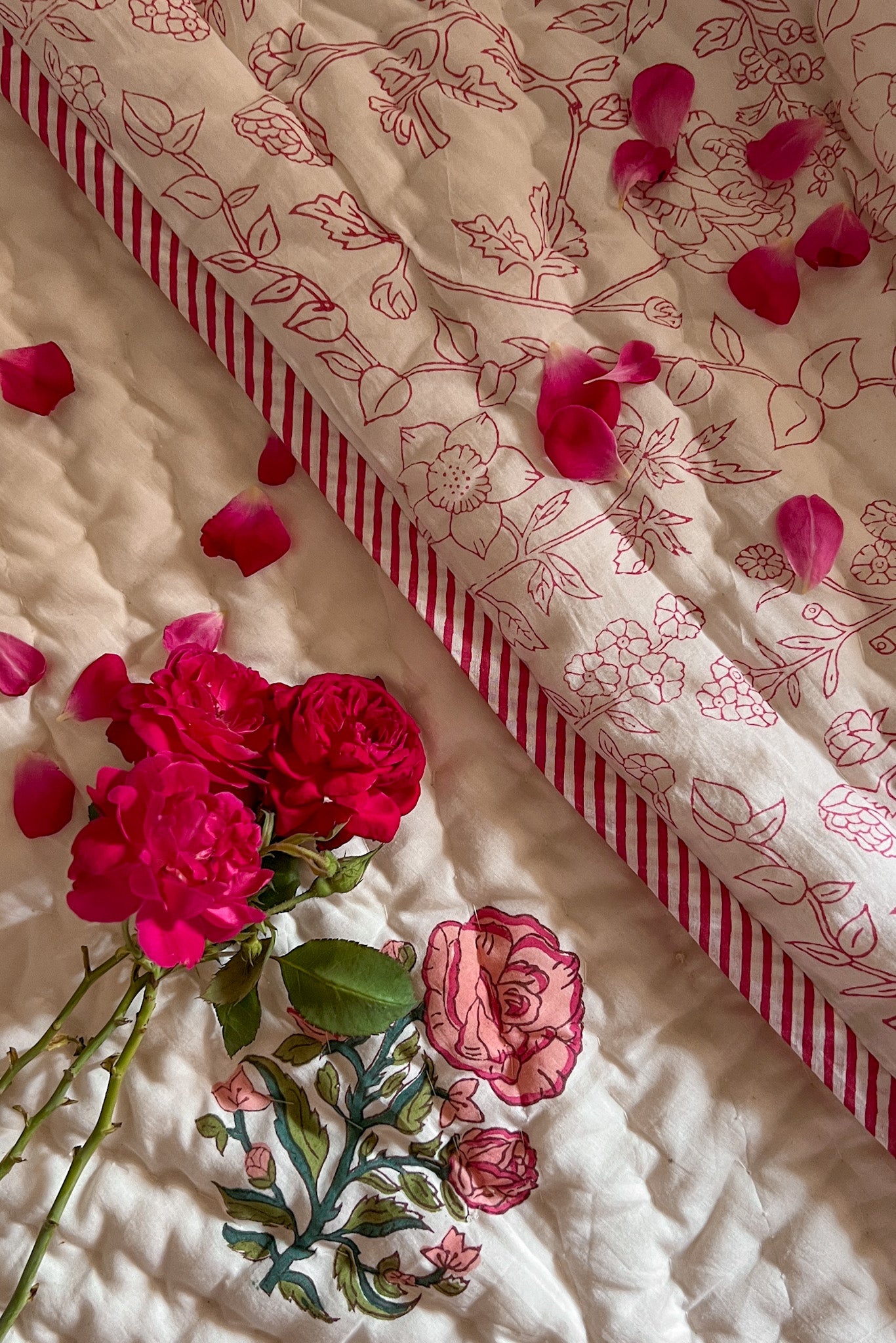 Detail of block printed roses on bed quilt