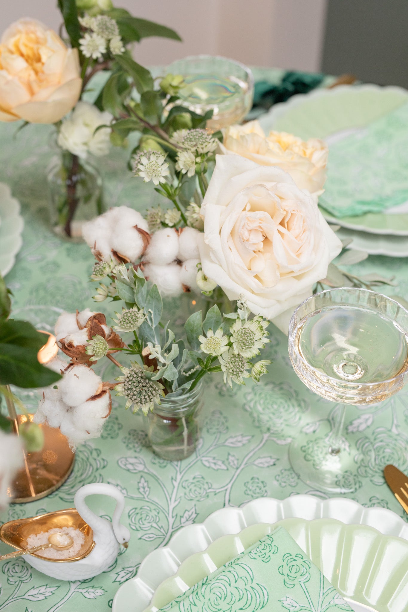 Detail of flowers in bud vase on green tablescape