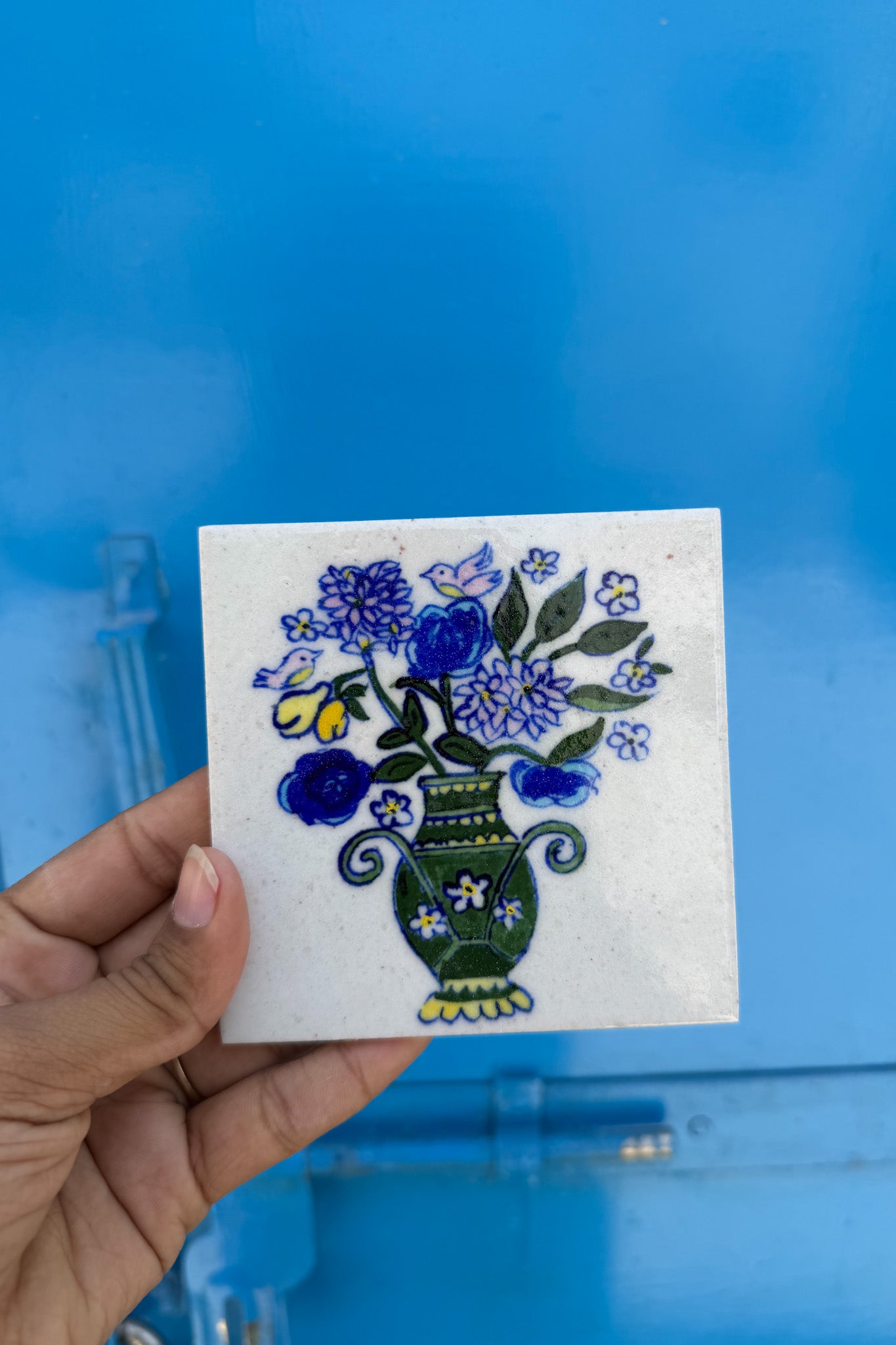 Blue pottery tile with vase