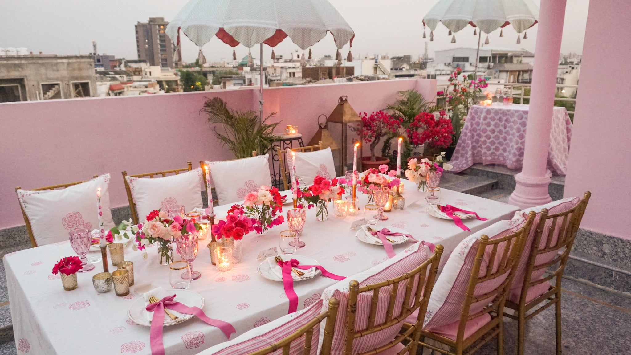 Candles lit on a pink tablescape in Jaipur