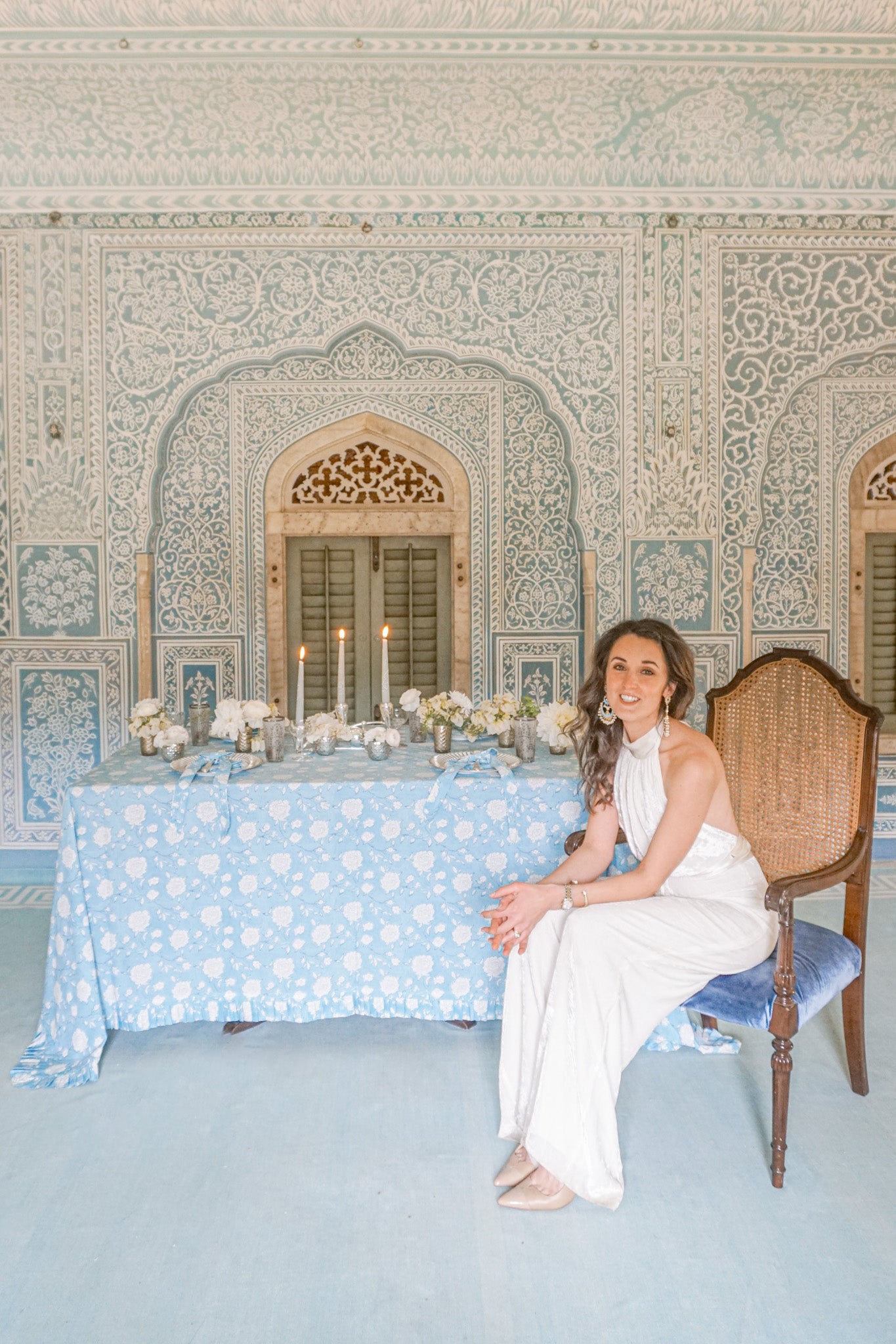 Rosanna Falconer next to the Peony Bloom tablescape at Samode Palace blue room