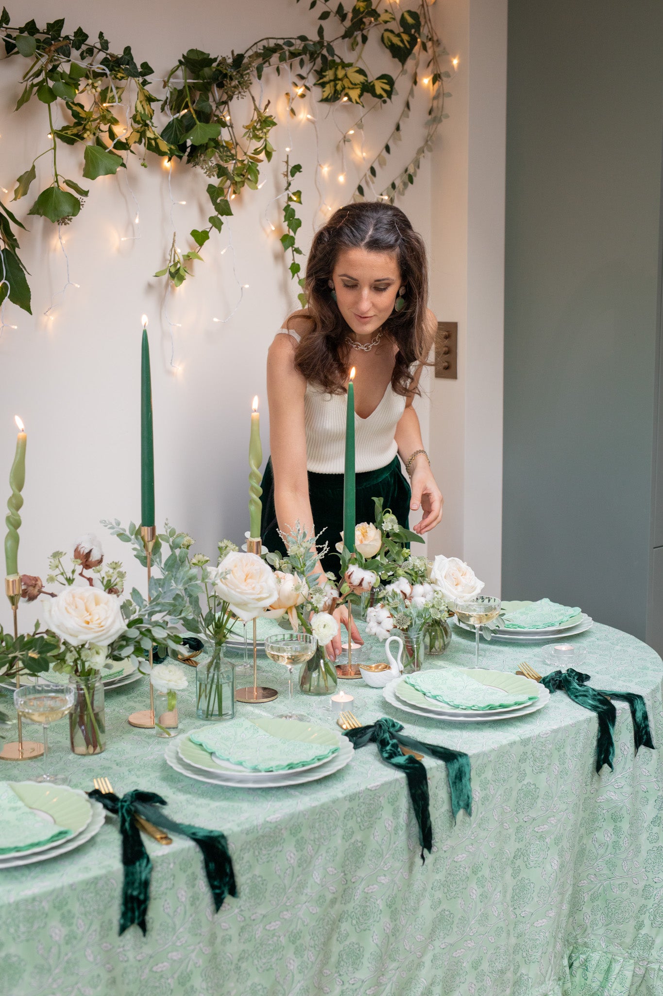 Rosanna Falconer arranges festive tablescape with rose block printed green tablecloth