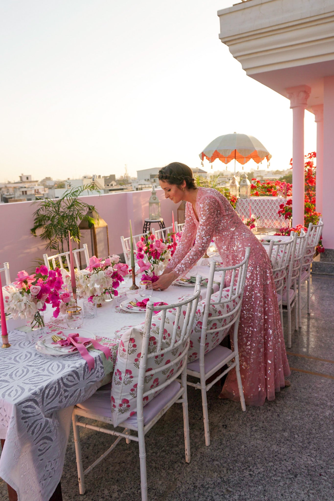 Rosanna Falconer in pink sequin dress arranges tablescape in Jaipur