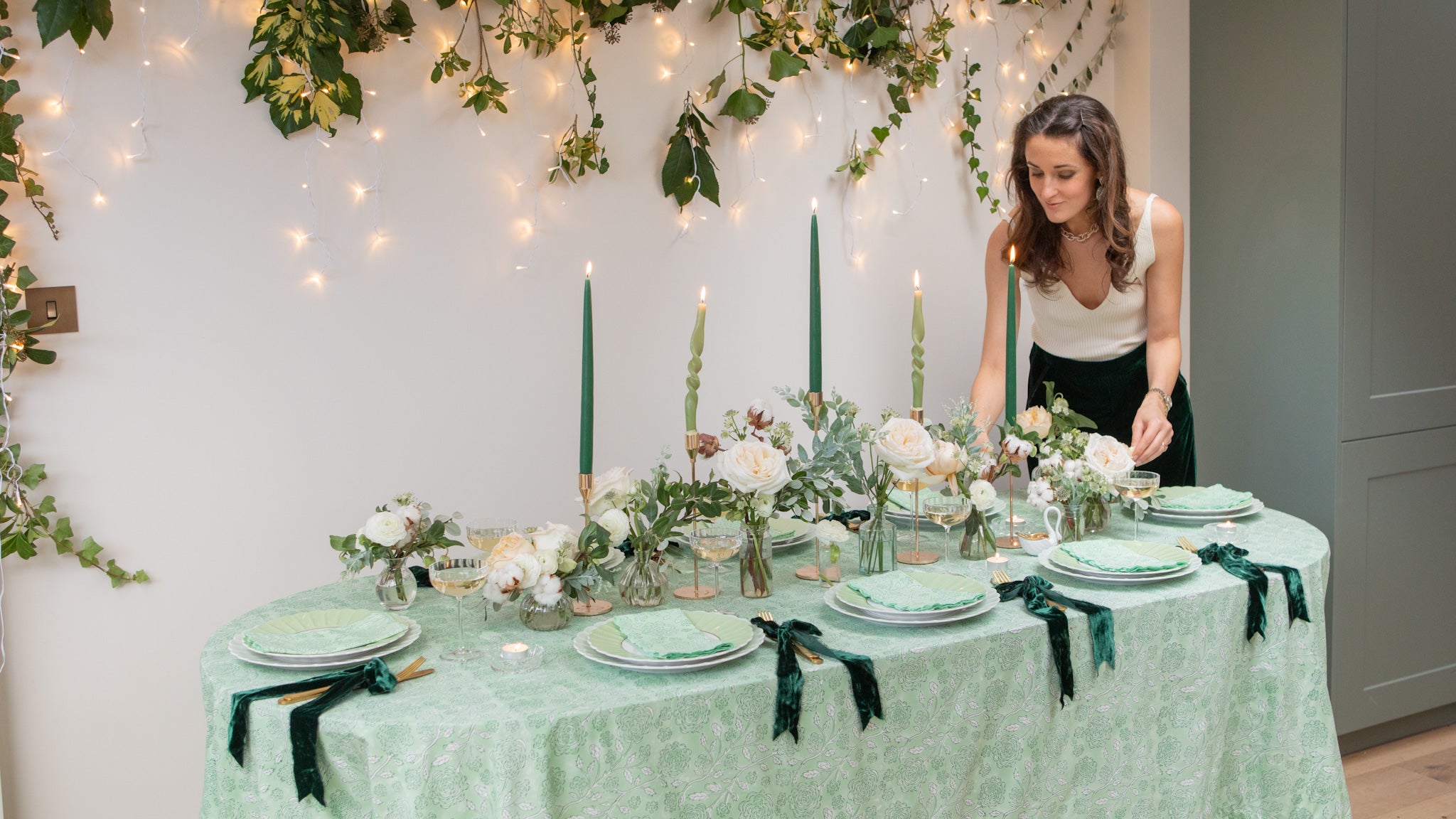 Rosanna Falconer arranges festive tablescape with rose block printed green tablecloth